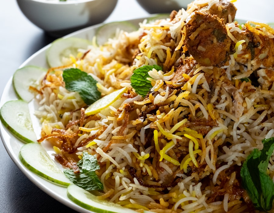 Chicken dum biryani served with mirchi ka salan and raita
