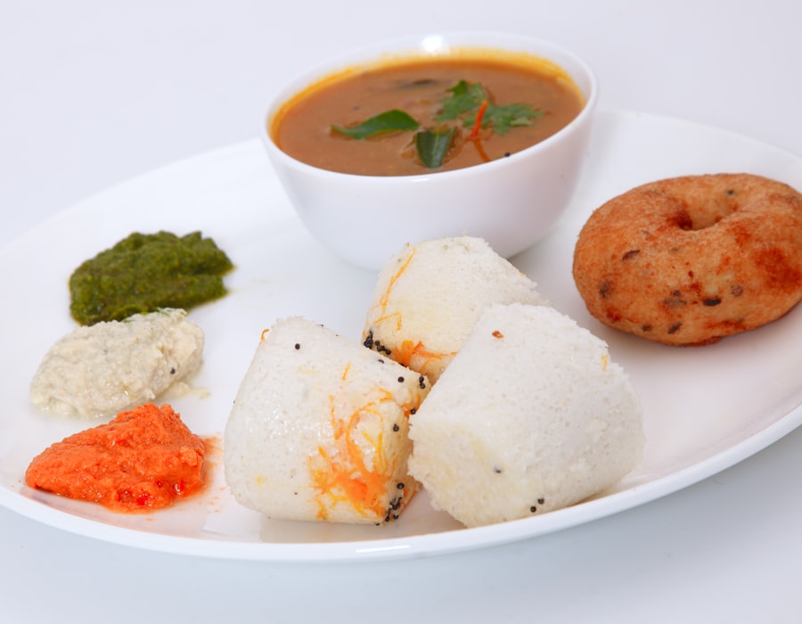 Fried breakfast fritters with sambar and chutney