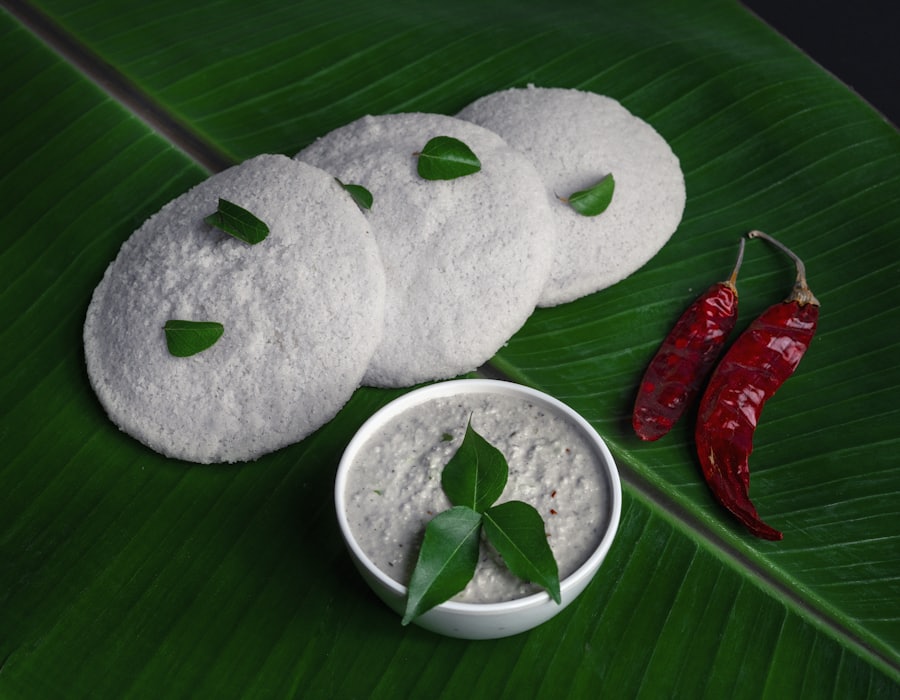 Soft idlis with chutney on a banana leaf